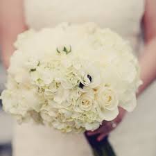 At this winter wedding, the bridesmaids' bouquets consisted of beeswax candles surrounded in olive branch, seeded eucalyptus, garden roses, ranunculus, amaranthus, and astilbe. White Roses Archives Bouquet Wedding Flower