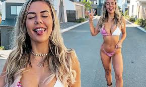 Shelby Bilby teases fans with a peek of her bare derrière in a revealing swimwear