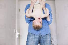 Browse 230 holding baby upside down stock photos and images available, or start a new search to explore more stock photos and images. Father Holding Baby Upside Down Stock Photo Dissolve