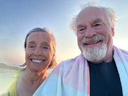 Red and white fishing trawler stuck