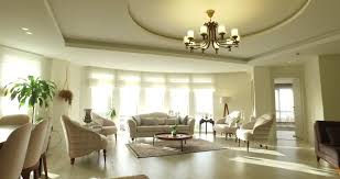 Modern apartment living room lighting. Tracking Shot Of Luxury Modern Apartment Interior Design With Natural Lighting With Colorful Flowerpot Chandelier Persian Carpet Candlestick Beige Sofa Orchid Living Room