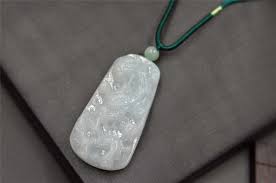 Cast in sterling silver, this pendant necklace features a blue jade gemstone overlaid with rock crystal and accented with 0.04 carat genuine diamonds. Light Blue Jade Dragon Pendant Necklace Helen Grade A Jade