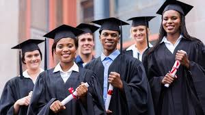 A group of diverse university graduates celebrating with caps and gowns.