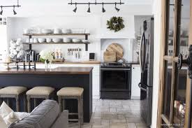 Solid white oak beams with custom natural stain, brass hardware and natural marble countertops and backsplash create the ultimate background for this black and white modern farmhouse kitchen designed by one of my favorite cabinet designers, stonington cabinetry & designs. Our Modern Farmhouse Kitchen Makeover The Reveal