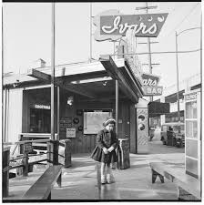 Cheryl Inez Smith standing in front of Ivar's, Seattle, circa 1953