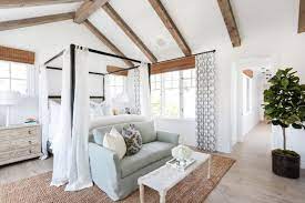 This poster bed features sleek tapered legs and detailed geometric paneling along the headboard. 24 Canopy Beds We Re Swooning Over Hgtv