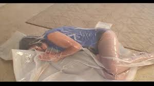 BoundHub - Girl vacuum sealed in white plastic bag