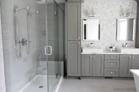 This william guidero planning and design bathroom uses gray and white stripes on the wall to make the area look bigger and also gives a very chic look. Sophisticated Gray And White Bathroom Design Pelham And White