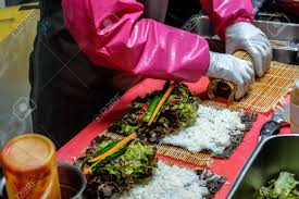 Though some may refer to kimbap as a korean sushi roll, that's a misnomer. Woman Hands Rolling Korean Seaweed Rice Roll Or Kimbap Sometimes Spelled Gimbap Gimbap Kimbap Is A