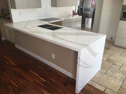 Sometimes also called risers, waterfall style refers to the way the quartz, granite, or marble countertops extend down the side of an island or cabinet, all the way to the floor. Beautiful Kitchen Done With Brittanica Cambria Quartz Edge Detail Kitchen Remodel Software Cambria Countertops Kitchen Design