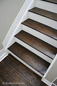 Paint and carpet runner or other covering white risers would, inevitably, get kicked and a wood finish actually doesn't show such wear as obviously as paint, especially white paint. Wood And White Stair Makeover Diy Staircase Staircase Remodel Stair Makeover
