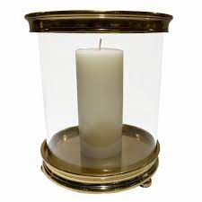 Clear glass hurricane lamp candle holders on aluminum round pedestal bases with contoured aluminum stems. Large Gold Cylinder Aluminum Hurricane Candle Holder Dessau Home Bc446