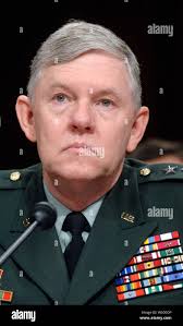 U.S. Army Lt. Gen. Michael X. Garrett, U.S. Army Central (USARCENT)  commanding general, poses for a photo with, from left, U.S. Army Col. Jason  Liddell, U.S. Army Sgt. William Ozemok, and U.S.