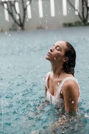Woman In A Pool Swimming In The Rain By Cloud Studio For Stocksy United Rain Photography Pool Photography Swimming Pool Photography