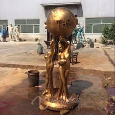 Paperweight features globe being held by three women, with the words the world is yours. The World Is Yours Statue Vincentaa