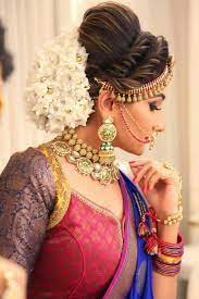 What A Beautiful Large Low Bun Covered With Jasmine Flowers Care However Should Be Taken Before Adopting Bridal Hair Buns Hair Styles Indian Bridal Hairstyles