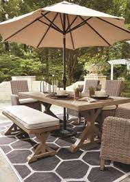 If your patio doesn't have an awning or sunshade, incorporating a gazebo, canopy or pergola into your. Beachcroft Dining Table With Umbrella Option Ashley Furniture Homestore Outdoor Patio Table Backyard Furniture Easy Patio Furniture