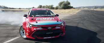 The 2019 corolla hatchback is a little bit bigger than the corolla im, and it features a new engine, two new transmissions, and numerous standard advanced safety features. Camaro Races Toyota Corolla Drift Car Video Gm Authority