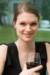 Italy, Tuscany, Siena, young woman tasting red wine in a vineyard at sunset  stock photo