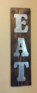 How to hang a picture. Metal Letters Attached To Stained Piece Of Wood Creating A Eat Sign To Hang In Kitchen Metal Tree Wall Art Tree Wall Art Diy Metal Tree