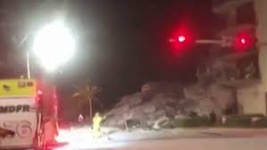 (ap) — a beachfront condo building partially collapsed thursday outside miami, killing at least one person and trapping others in the tower that resembled a giant fractured dollhouse, with one side sheared away. H7il8oeq8 M3km