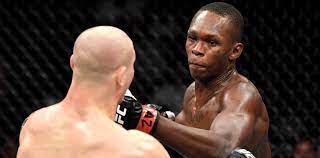 Israel adesanya of nigeria punches marvin vettori of italy in their ufc middleweight championship fight during the ufc 263 event at gila river arena on june 12, 2021. Pubgsxbyzr7z4m