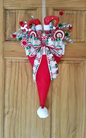 Draw a line of hot glue down the back of the dowel to secure everything; Christmas Holiday Upside Down Elf Santa Hat Door Decor Wreath Candy Handmade Bow Xmas Decor Xmas Decorations Diy Christmas Decorations To Make Xmas Crafts