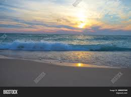 Decorate your desktop with this stunning tropical sunset beach palm tree ocean waves sky clouds wallpapers hd wallpaper. Waves On Beach Sunset Image Photo Free Trial Bigstock