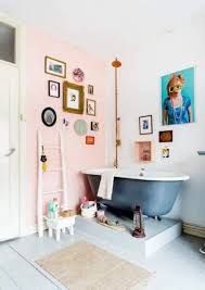 A small boho bathroom with a mosaic tile floor, grey and white tile walls, a tub, potted greenery and baskets for storage. 25 Latest Best Bathroom Designs With Pictures In 2021