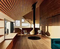 Wood is often incorporated into the design of a space through walls, wood slats, and flooring. 20 Suspended Fireplaces Dwell