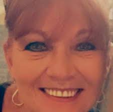 How many times do I need to visit Aruba to get a certain status?