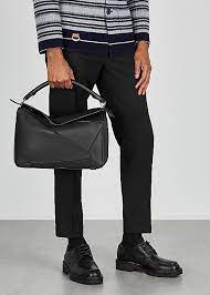The first bag designed after jonathan anderson was appointed creative director in 2014, the puzzle bag from loewe exudes modern artistry with its innovative cuboid shape that takes 524 actions to complete and perfect. Loewe Puzzle Large Black Leather Shoulder Bag Harvey Nichols