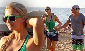 Paris Hilton swaps her bikini piece for a one piece as she shows off her  more curvaceous figure