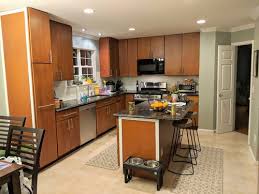 You can change the color of your stained oak cabinets, but it will require time and effort. Refinishing Kitchen Cabinet Design Color Help