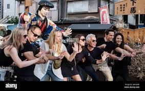 Friends are posing in front of a local Japanese Samurai statue straight to  the hidden camera, Tokyo streets, Japan Stock Photo - Alamy