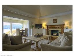 Imagine Enjoying This Stunning Western Lake Vista From Nearly Every Window And From Your Stone Veranda Daily Unique And Styli Home Spacious Living Living Area
