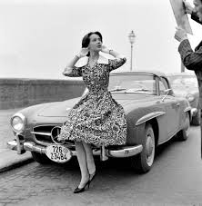 Model Poses On Mercedes Benz 190sl Roadster In Floral Print Summer Dress With White Pique Collar A Floral Print Dress Summer Mercedes Benz Mercedes Benz Models