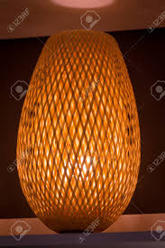 Adesso 3004 sebu 2 light 50 high column table lamp teak finish bamboo lamps table lamps build, inc. Weave A Bamboo Lamp And A Bright Light On A Table A Concept Of Stock Photo Picture And Royalty Free Image Image 97736728