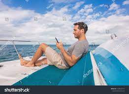 Boat Man Using Mobile Phone Texting On Satellite Internet While Relaxing On Deck Of Yacht Luxury Lifestyle Ad Used Mobile Phones Photo Editing Mobile Phone
