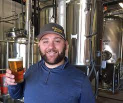 We are family friendly with a cool vibe and a casual environment established in 2014. Sound To Summit Brewing Owner John Carruthers With Collectible Pint Glass 2 2 Mltnews Com