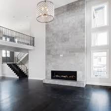 Accentuate The Height Of Your Living Space By Extending Your Tile Design From Floor To Ceiling Tha Fireplace Tile Tiled Fireplace Wall Fireplace Tile Surround