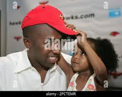 Atlanta Hawks newly-acquired point guard Speedy Claxton gets help with his  Hawks cap from his 3-year-old daughter Aniya as he speaks to reporters  after a news conference, Wednesday, July 12, 2006, in