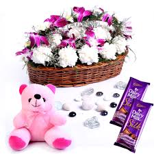 Teddy bear with one dozen red roses and chocolates. Basket Of Orchids And Carnations With Chocolates And Teddy Bear Winni In