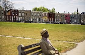 A Photo Of A Man Sitting On A Bench In East Baltimore Being A Landlord Renter Section 8