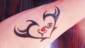 Human hand isolated with a love tattoo on her finger. Beautiful Heart And Love Tattoo Design Simple Heart Tattoo Youtube