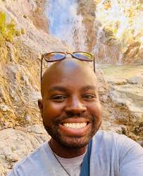 Can someone remove the lanyard from my husband's neck in this photo?