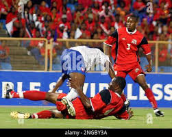Panama's Kenwyne Jones takes a fall with Trinidad and Tobago defender  Marvin Andrews as Emery Avery John looks during their CONCACAF finals round  qualifer match for the 2006 World Cup at the Hasely Crawford Stadium in  Port Of Spain, Trinidad
