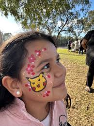 Shoppers model face paintings at market event