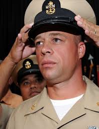 Chief Culinary Specialist James Reid receives his chief petty officer  combination cover during a traditional Chief Pinning Ceremony.
