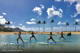 Standup paddleboard yoga is a unique adventure that combines the physical challenges of practicing yoga on a paddleboard with the majestic beauty of hawaii's oceans and shorelines. Yoga With A Twist Hawaiian Airlines